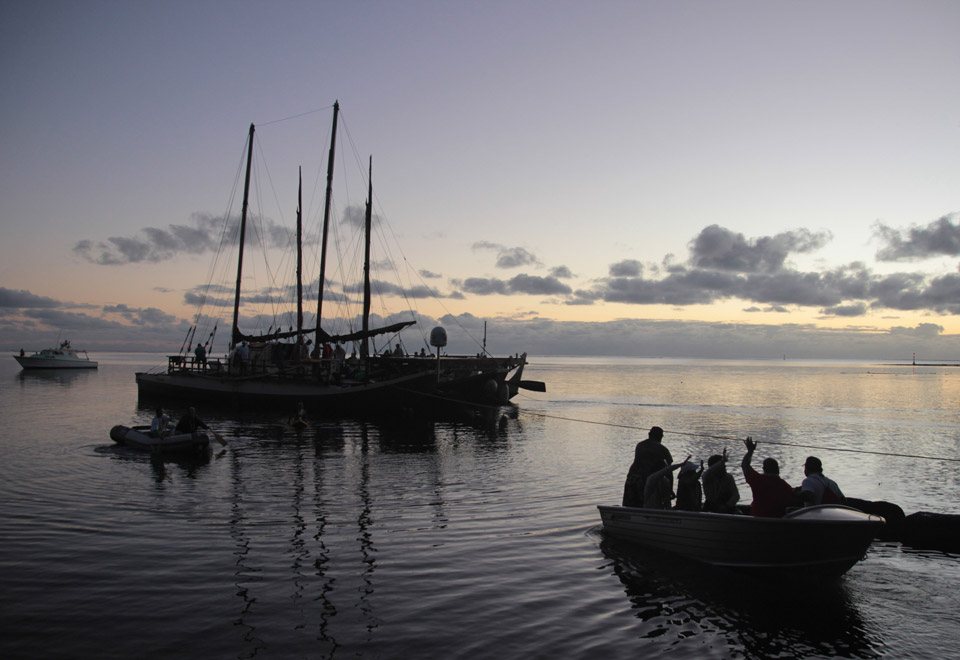 Hokule‘a and Hikianalia leave Tautira, Tahiti, as the leg from Tahiti to Samoa begins. The canoes are making their way to the island of Moorea. (Photo courtesy BRYSON HOE-COMMUNICATIONS LIAISON - WORLDWIDE VOYAGE)