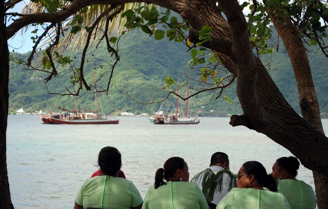 Samoan villagers watched the arrival of Hokule'a and Hikianalia in Pago Pago Harbor on Thursday. (Courtesy Lorn Cramer via Barry Markowitz) 