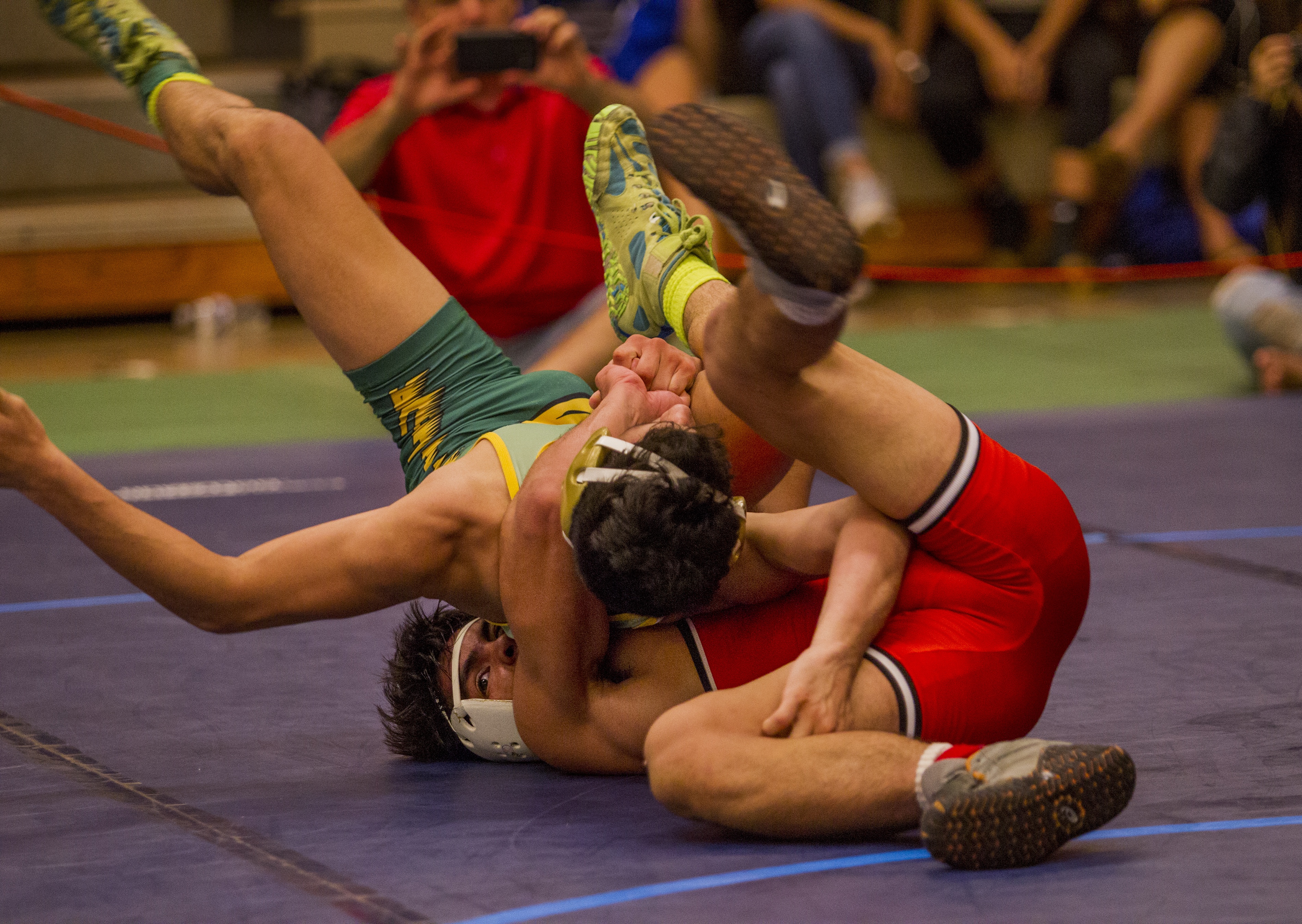 Tristan Santos (Campbell, on the bottom) throws Kaena Desantos (Leilehua) i...