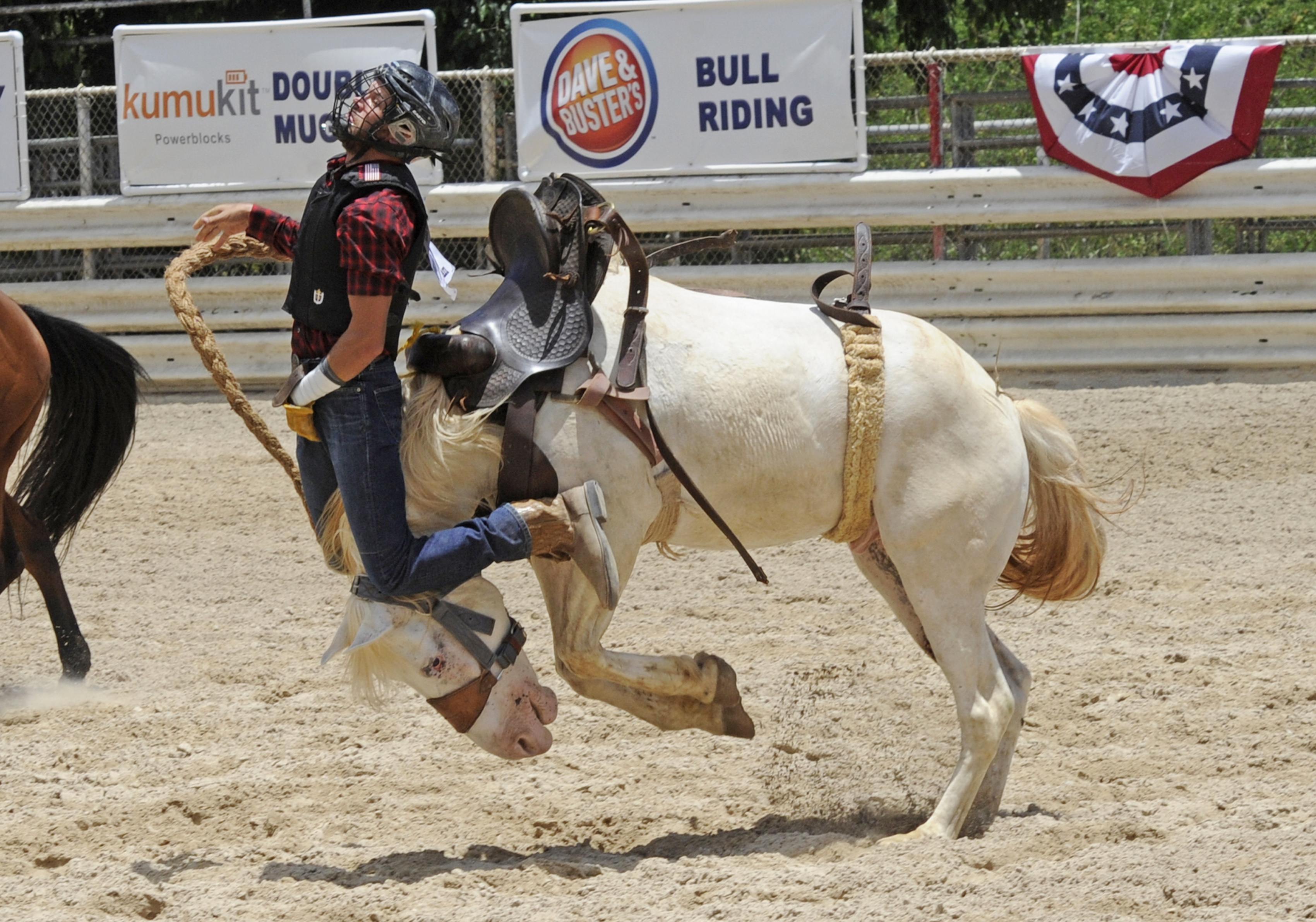 Bronc rider Timothy Bessinger is thrown in the Bronc Riding event in the Al...