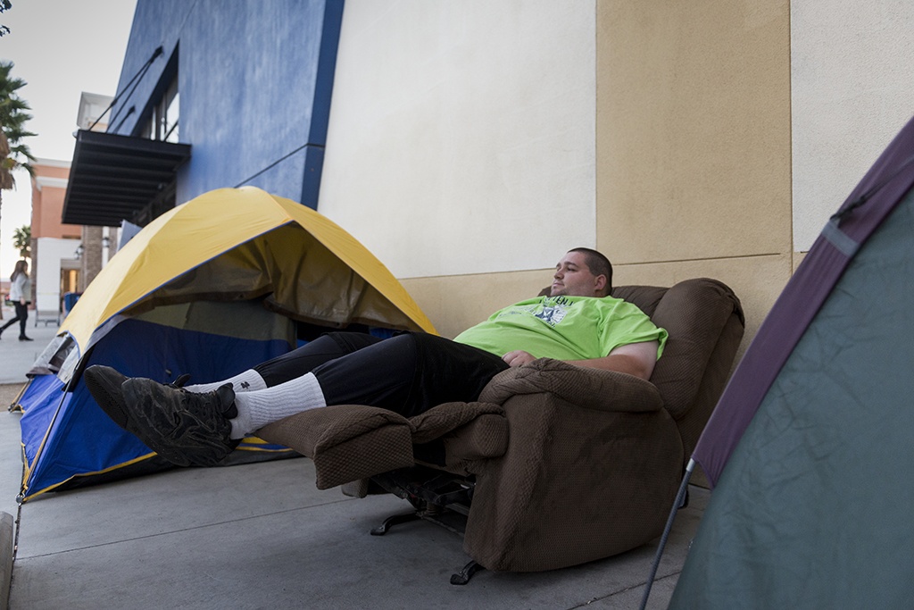 Cameron Miller kicks back in a recliner while camping out at Best Buy in Apple Valley, Calif. Only two groups of customers have shown up early at the location this year in advance of Black Friday.