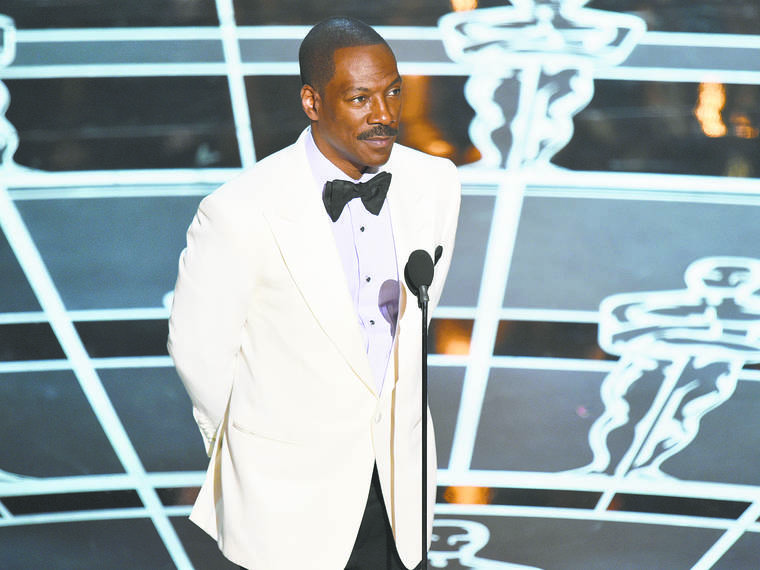ASSOCIATED PRESS
                                Eddie Murphy presents the award for best original screenplay at the Oscars in 2015.