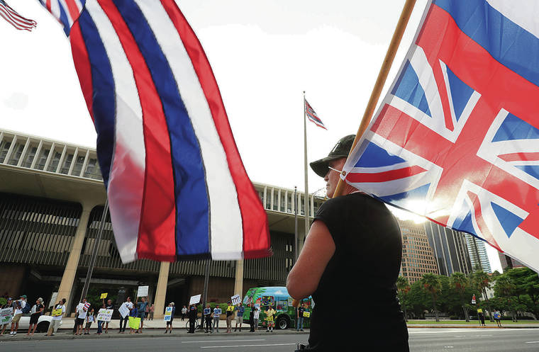 JAMM AQUINO / AUGUST 1
                                Thirty Meter Telescope opponent Mahealani Martin protested across Beretania Street from supporters at the state Capitol. Residents for and against TMT have criticized how state officials have handled Mauna Kea.