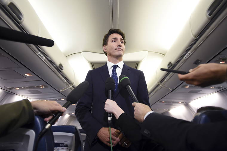 SEAN KILPATRICK/THE CANADIAN PRESS VIA AP
                                Canadian Prime Minister and Liberal Party leader Justin Trudeau makes a statement in regards to a photo coming to light of himself from 2001, wearing “brownface,” during a scrum on his campaign plane in Halifax, Nova Scotia.