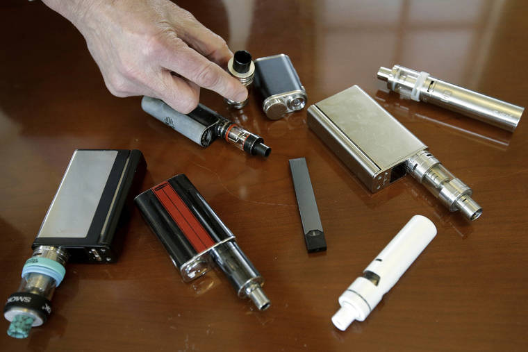 ASSOCIATED PRESS
                                A high school principal displayed vaping devices, in April 2018, that were confiscated from students at the school in Massachusetts. The Centers for Disease Control and Prevention said 805 confirmed and probable cases have been reported to have a vaping-related breathing illness, and the death toll has risen to 13.