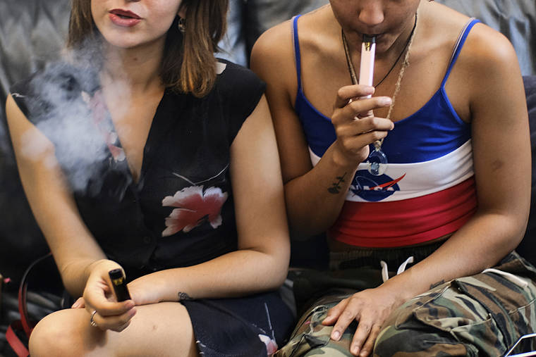ASSOCIATED PRESS / JUNE 8
                                Two women smoke cannabis vape pens at a party in Los Angeles. The Centers for Disease Control and Prevention said more than three-quarters of the 805 confirmed and probable illnesses from vaping involved THC, the ingredient that produces a high in marijuana.