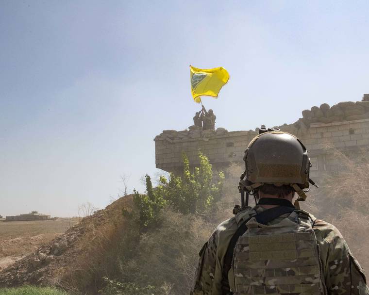 U.S. ARMY PHOTO BY STAFF SGT. ANDREW GOEDL VIA AP / SEPT. 21
                                A U.S. soldier oversees members of the Syrian Democratic Forces as they demolish a Kurdish fighters’ fortification and raise a Tal Abyad Military Council flag over the outpost as part of the so-called “safe zone” near the Turkish border.