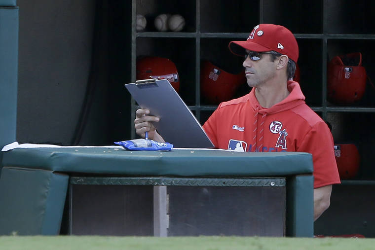 ASSOCIATED PRESS
                                Los Angeles Angels manager Brad Ausmus picks up his clipboard after the last out in the ninth inning as the Houston Astros defeat his team in a baseball game in Anaheim, Calif., on Sunday.