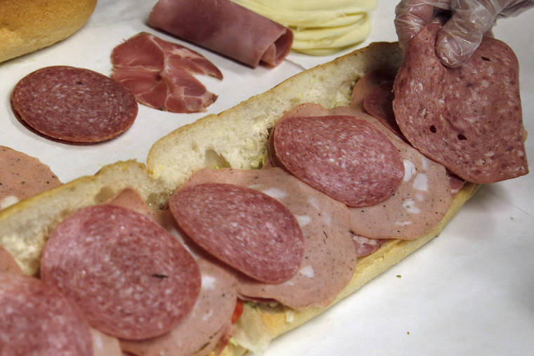 ASSOCIATED PRESS
                                A man made a submarine sandwich, in June 2014, with mortadella, cooked salami, ham, Genoa salami and sweet capicola at a delicatessen in Massachusetts. An international team of researchers is questioning the advice to limit red and processed meats, saying the link to cancer and heart disease is weak.