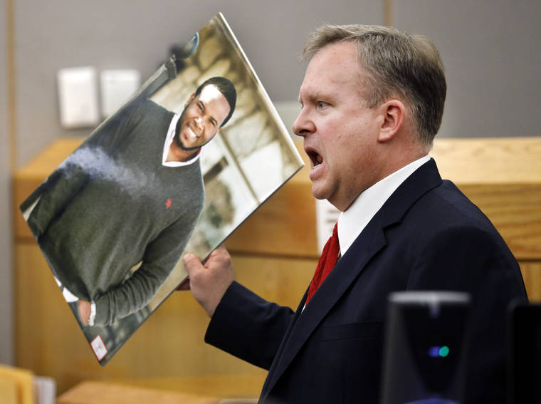 ASSOCIATED PRESS
                                Assistant District Attorney Jason Hermus waves a photo of Botham Jean at the jury as he presents his closing arguments in Amber Guyger’s murder trial in the 204th District Court at the Frank Crowley Courts Building in Dallas, today. Guyger shot and killed Botham Jean, an unarmed 26-year-old neighbor in his own apartment last year. She told police she thought his apartment was her own and that he was an intruder.