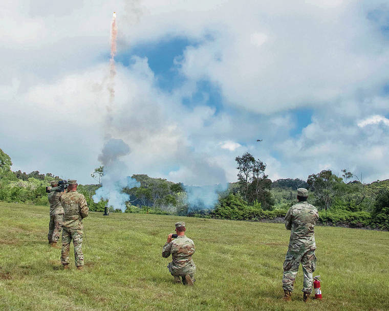 CRAIG T. KOJIMA /CKOJIMA@STARADVERTISER.COM
                                The 25th Combat Aviation Brigade conducted “aviation mission survivability” training Friday within the Schofield Barracks East Range using a man-portable aircraft survivability trainer (MAST) that resembles a rocket launcher, at left.
