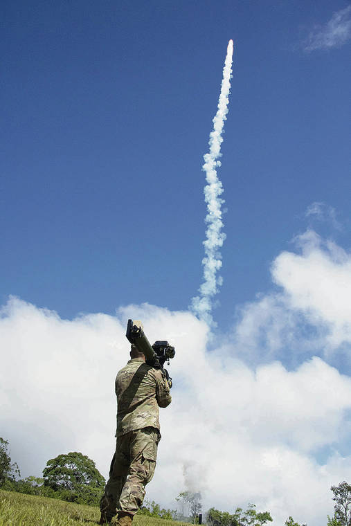 CRAIG T. KOJIMA /CKOJIMA@STARADVERTISER.COM
                                Spc. Tyler Billings takes aim with a man-portable aircraft survivability trainer (MAST). The flare launched was a visual cue for the helicopter pilot to begin evasion procedures.