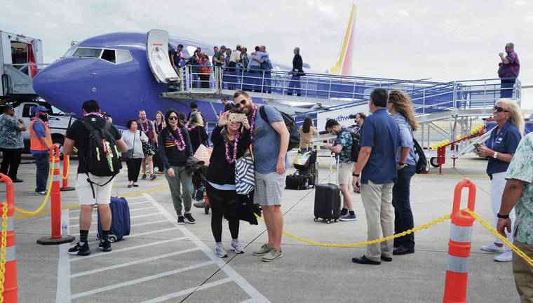 BRUCE ASATO / MARCH 17
                                Passengers deplane in Honolulu from Southwest Airlines’ inaugural flight from Oakland, Calif.
