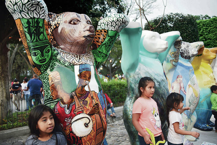 TRIBUNE NEWS SERVICE
                                Guatemalans visit the traveling exhibition “United Buddy Bears, The Art of Tolerance” at the Plaza Mayor Antigua Guatemala. Each of the 144 2-meter-high colorful bears represents a United Nations member country.