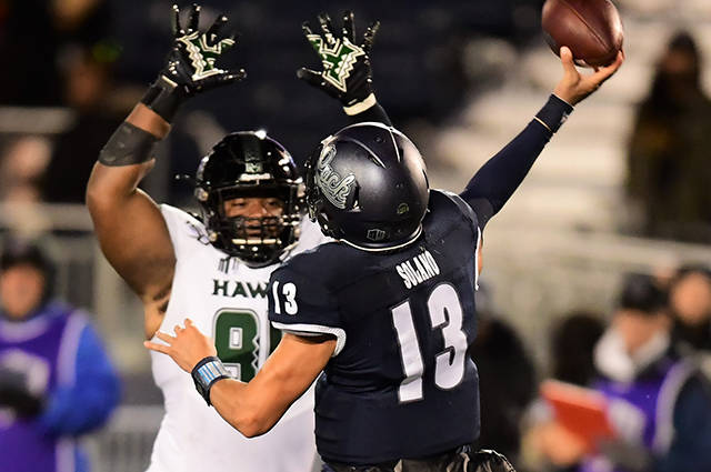 STEVEN ERLER / SPECIAL TO THE STAR-ADVERTISER
                                Hawaii Warriors defensive lineman Kendall Hune (95) rushed Nevada Wolf Pack quarterback Cristian Solano (13) during the second of a game between the Warriors and the Nevada Wolf Pack on Saturday in Reno, Nev.