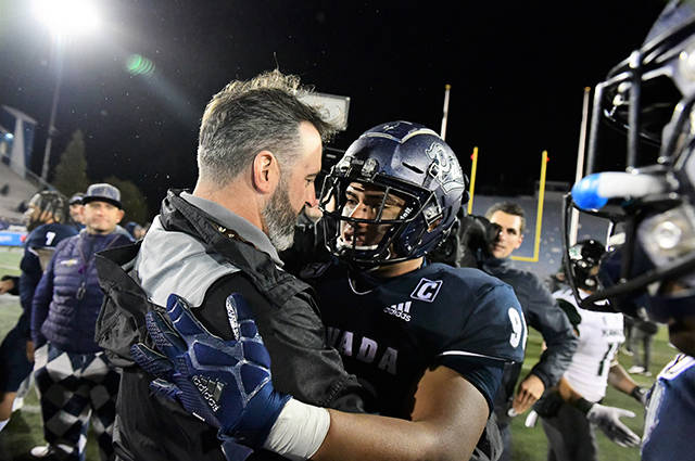 STEVEN ERLER / SPECIAL TO THE STAR-ADVERTISER
                                Hawaii Warriors head coach Nick Rolovich met with Nevada Wolf Pack defensive end Adam Lopez (91) after a game Saturday between the Warriors and the Nevada Wolf Pack at Mackay Stadium in Reno, Nev.