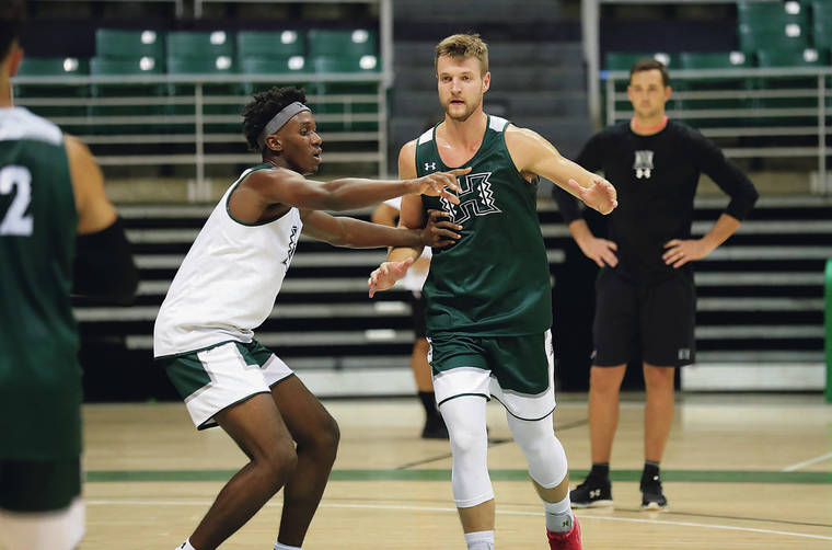 JAMM AQUINO/JAQUINO@STARADVERTISER.COM
                                Hawaii forward Zigmars Raimo (14) defends against forward Zoar Nedd (20) during the first day of fall basketball practice on Saturday at the Stan Sheriff Center in Honolulu.