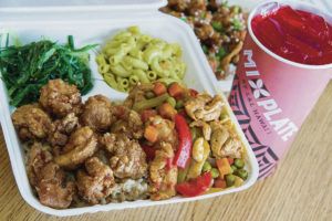 CRAIG T. KOJIMA / 2017
                                Garlic chicken and chicken guisantes pair up at L&L’s Mixplate location.