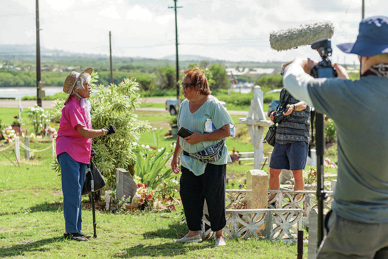 RON KOSEN / SPECIAL TO THE STAR-ADVERTISER
                                Catherine Lo, left, and Stephanie Castillo at the Hanapepe Massacre documentary launch at the Filipino cemetery in Hanapepe, Kauai.
