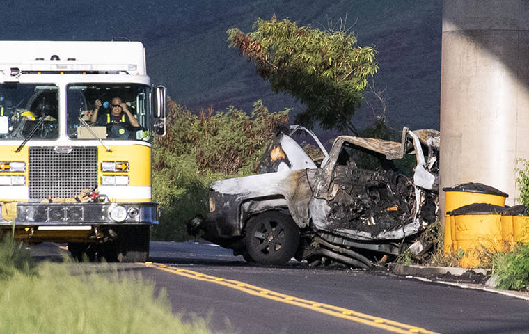 CRAIG T. KOJIMA / CKOJIMA@STARADVERTISER.COM
                                Firefighters worked at the scene of a fatal crash on Farrington Highway near Kahi Mohala in Ewa, Oct. 2. Honolulu police are investigating the crash as a murder-suicide.