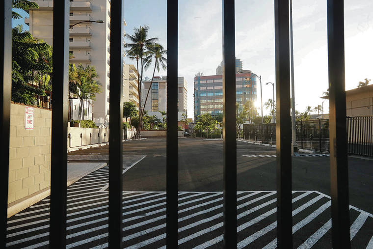 CINDY ELLEN RUSSELL / CRUSSELL@STARADVERTISER.COM
                                Entry to the municipal parking lot along Kuhio Avenue near Kaiolu Street remains blocked more than a year after construction of the Ritz-Carlton Residences’ second tower was completed.
