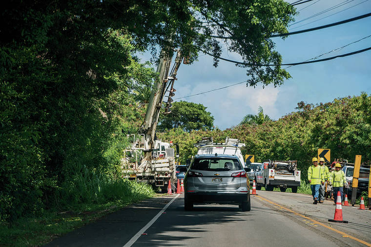 DENNIS ODA / DODA@STARADVERTISER.COM
                                Utility crews work on restoring power on Oct. 18, 2019 after a utility pole was cut down along Kamehameha Highway on the North Shore.