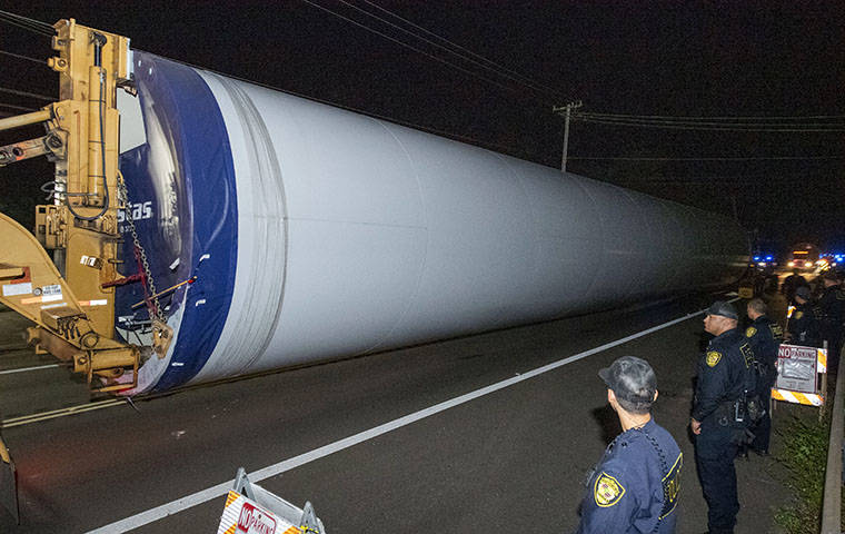 CRAIG T. KOJIMA / CKOJIMA@STARADVERTISER.COM
                                A large piece of a wind turbine was transported early Tuesday morning in Kahuku as protests continued.