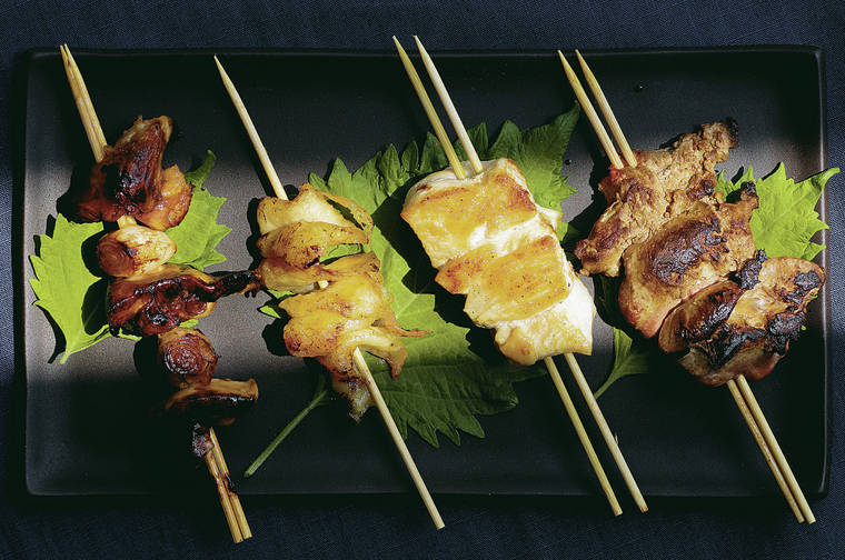 TRIBUNE NEWS SERVICE
                                Yakitori (or chicken on a skewer) versions, left to right, tare style, torikawa, with shio (or salt) and reba (or livers).