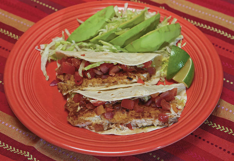 TRIBUNE NEWS SERVICE
                                Linda Gassenheimer’s Quick Fix Fish Tacos with Avocado Salad.