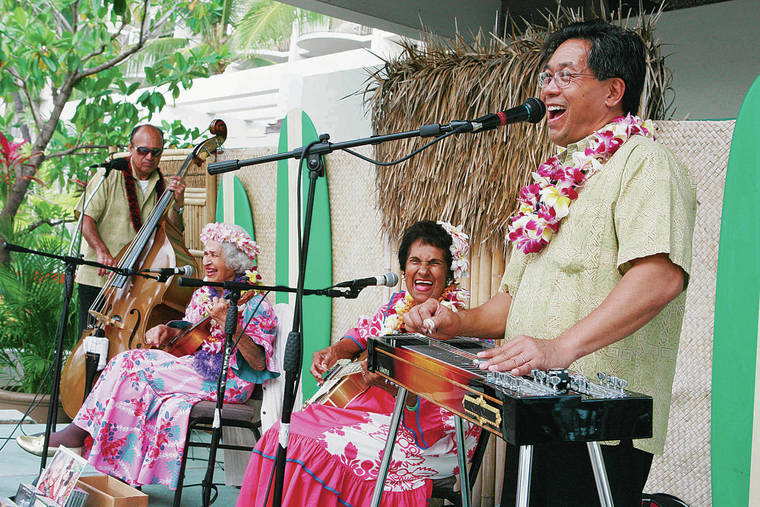 GEORGE F. LEE / 2007
                                Momi Kahawaiola‘a, seated right, performed with her aunt Genoa Keawe for years. Performing with them at far right is pedal steel guitar player Alan Akaka.