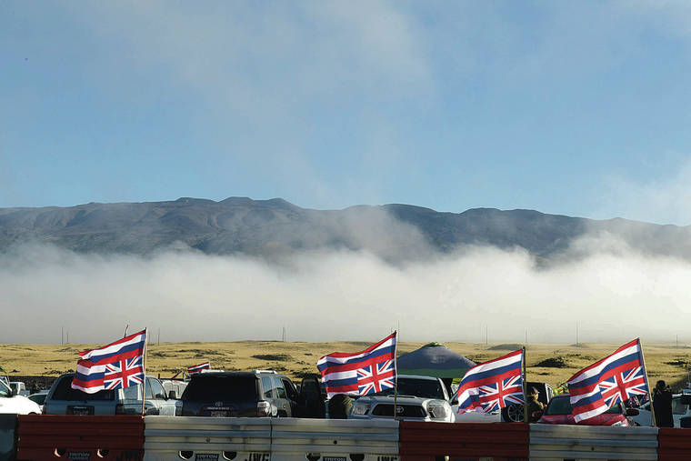 BRUCE ASATO / JULY 20
                                The morning mist that brought light showers clears and reveals the summit of Mauna Kea.