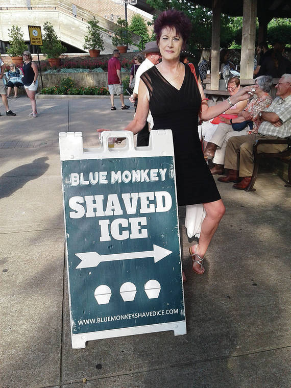 While visiting the Grand Ole Opry in June, Frankie L. Ruggles-Quinabo discovered Blue Monkey Shaved Ice in Nashville, Tenn. Its menu included POG flavor, which she defined for a customer. Photo by Edgar Quinabo.