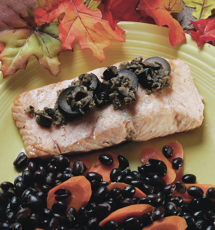 TNS
                                Roasted salmon is garnished with black olive sauce and served with black beans and carrots.