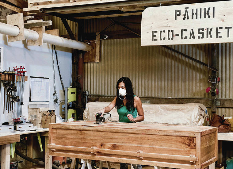 COURTESY CORTNEY GUSICK
                                Pahiki Eco-Caskets makes low-environmental-impact caskets out of Hawaii-grown wood. Pictured above is company founder Cortney Gusick working on a casket.