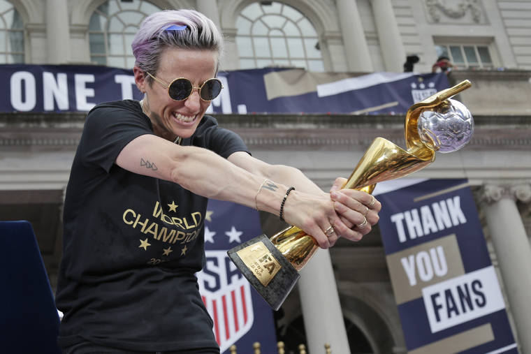 ASSOCIATED PRESS
                                U.S. women’s soccer player Megan Rapinoe celebrates with the FIFA Women’s World Cup trophy at City Hall after a ticker tape parade, July 10, in New York. The U.S. national team beat the Netherlands 2-0 to capture a record fourth Women’s World Cup title.
