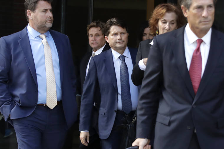 ASSOCIATED PRESS
                                Devin Sloane, middle, leaves federal court after his sentencing in a nationwide college admissions bribery scandal, Sept. 24, in Boston.