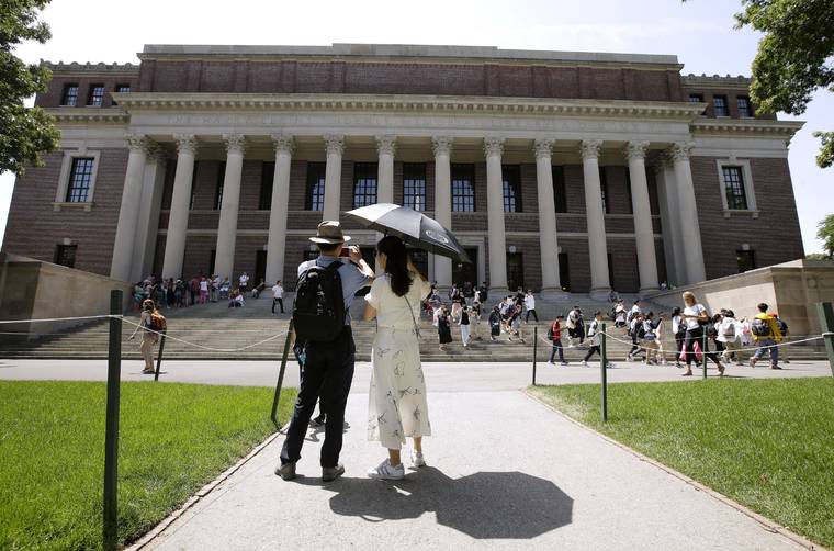 ASSOCIATED PRESS
                                People stopped to record images of Widener Library, July 16, on the campus of Harvard University in Cambridge, Mass. U.S. District Judge Allison D. Burroughs ruled, today, that Harvard does not discriminate against Asian Americans in its admissions process.