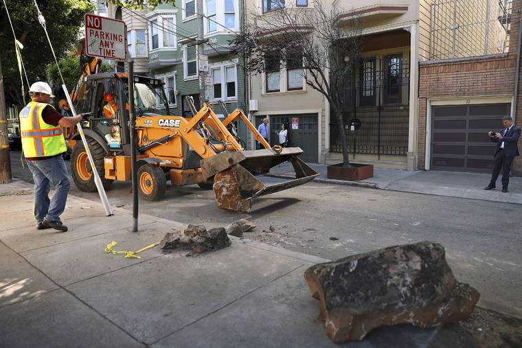 LIZ HAFALIA/SAN FRANCISCO CHRONICLE VIA ASSOCIATED PRESS
                                A San Francisco Public Works crew removed boulders from a sidewalk, Monday, along a street in San Francisco. A group of San Francisco neighbors said they bought boulders and had them delivered to their sidewalk to stop people from camping and dealing drugs on their street.