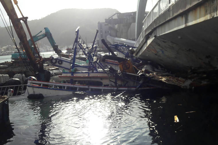 TAIWAN’S MILITARY NEWS AGENCY VIA AP
                                In this photo released by Ministry of National Defense, damaged ships are pulled after towering arch bridge collapsed in Nanfangao, eastern Taiwan. The 140-meter-long (460-feet) bridge collapsed, sending a burning oil tanker truck falling onto boats in the water below.