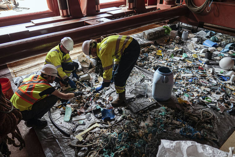 THE OCEAN CLEAN UP VIA ASSOCIATED PRESS
                                Crew members sort through plastic on board a support vessel on the Pacific Ocean.