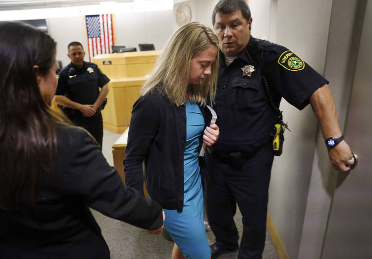 ASSOCIATED PRESS
                                Holding a Bible given to her by State District Judge Tammy Kent, former Dallas Police Officer Amber Guyger leaves court for jail following her sentencing, Wednesday, Oct. 2, 2019, in Dallas. Guyger, who said she mistook neighbor Botham Jean’s apartment for her own and fatally shot him in his living room, was sentenced to a decade in prison. (Tom Fox/The Dallas Morning News via AP, Pool)