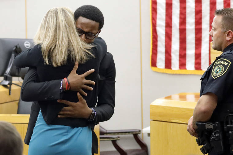 ASSOCIATED PRESS
                                Botham Jean’s younger brother Brandt Jean hugs convicted murderer and former Dallas Police Officer Amber Guyger after delivering his impact statement to her after she was sentenced to 10 years in jail, Wednesday, in Dallas. Guyger shot and killed Botham Jean, an unarmed 26-year-old neighbor in his own apartment last year. She told police she thought his apartment was her own and that he was an intruder.