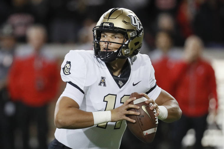 ASSOCIATED PRESS
                                UCF quarterback Dillon Gabriel looks to pass during the first half.