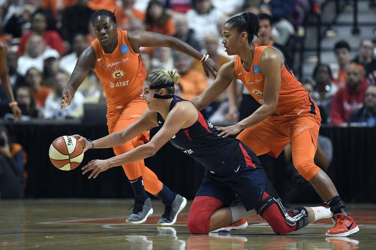 ASSOCIATED PRESS
                                Washington Mystics’ Elena Delle Donne, center, passes the ball between Connecticut Sun’s Shekinna Stricklen, left, and Alyssa Thomas, right, during the first half in Game 3 of basketball’s WNBA Finals, today in Uncasville, Conn.