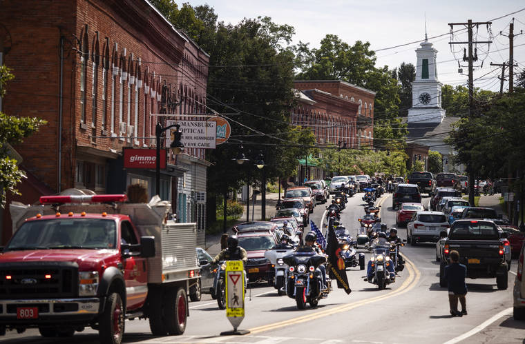 ASSOCIATED PRESS
                                A memorial procession for Sgt. James Johnston, who was killed in Afghanistan in June, passes through Trumansburg, N.Y., on Aug. 31. Two months after his death, his adopted hometown had come together over a holiday weekend to pay tribute, and to say goodbye.