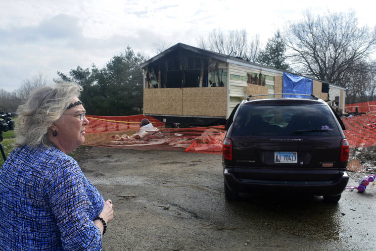 THE PANTAGRAPH VIA ASSOCIATED PRESS / APRIL 7, 2019
                                Marie Chockley, a resident of the Timberline Trailer Court, north of Goodfield, Ill., surveys the damage that was caused by a night fire that killed five residents in a mobile home.