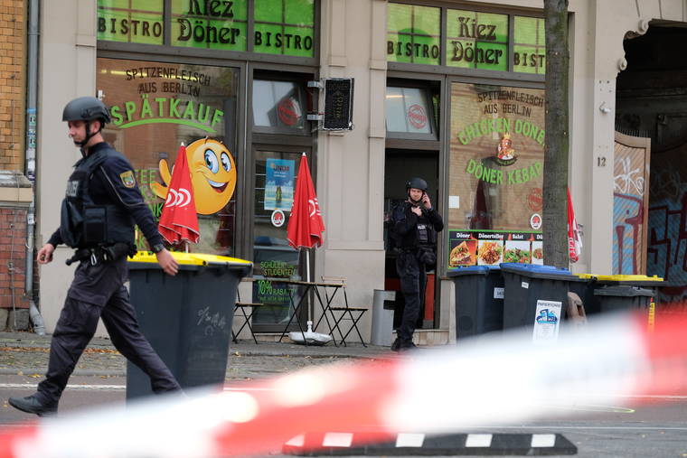 SEBASTIAN WILLNOW/DPA VIA ASSOCIATED PRESS
                                A police officer walked in front of a kebab grill in Halle, Germany, today. A gunman fired several shots, today, in the German city of Halle.