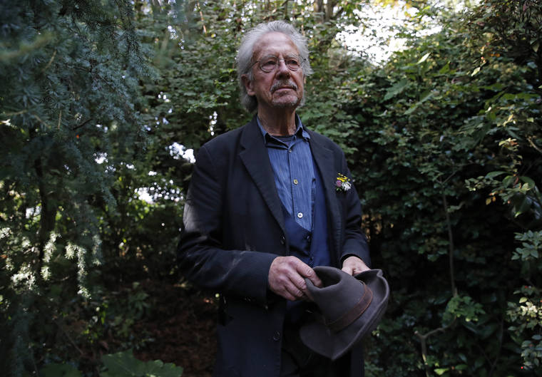 ASSOCIATED PRESS
                                Austrian author Peter Handke posed for a photo in his garden at his house in Chaville near Paris, today. Handke was awarded the 2019 Nobel Prize in literature earlier today.
