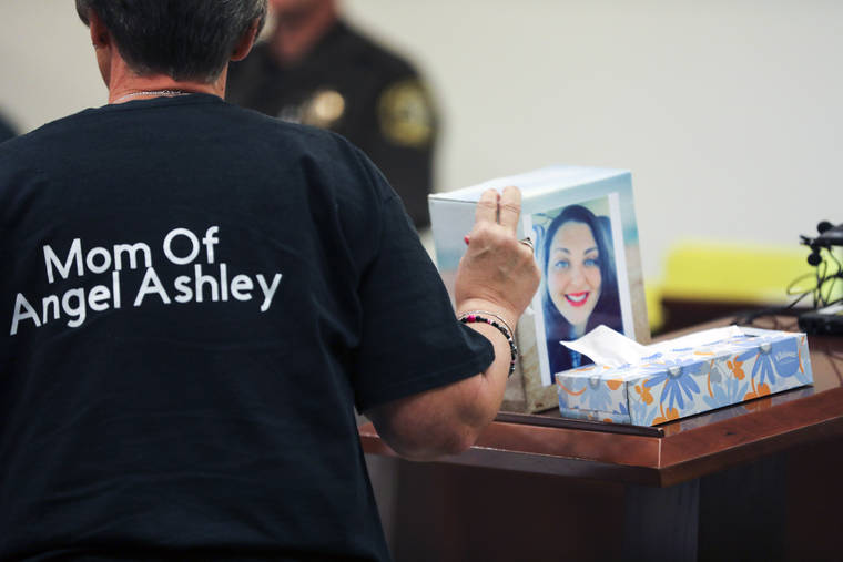 BRIAN HAYES/THE GRAND RAPIDS PRESS VIA AP
                                Kristine Young, mother of Ashley Young, gestures to a box containing her daughter’s ashes during the sentencing of Jared Chance in Kent County Circuit Court, Thursday, Oct. 10, 2019, in Grand Rapids, Mich. Chance, a Michigan man convicted of killing and dismembering Ashley Young has been sentenced to at least 100 years in prison after a judge called his actions “reprehensible and heinous.”
