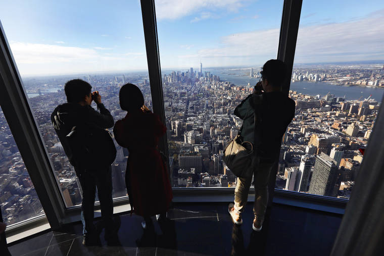 ASSOCIATED PRESS
                                People look at the south view in the 102nd-floor Observatory of the Empire State Building, in New York.